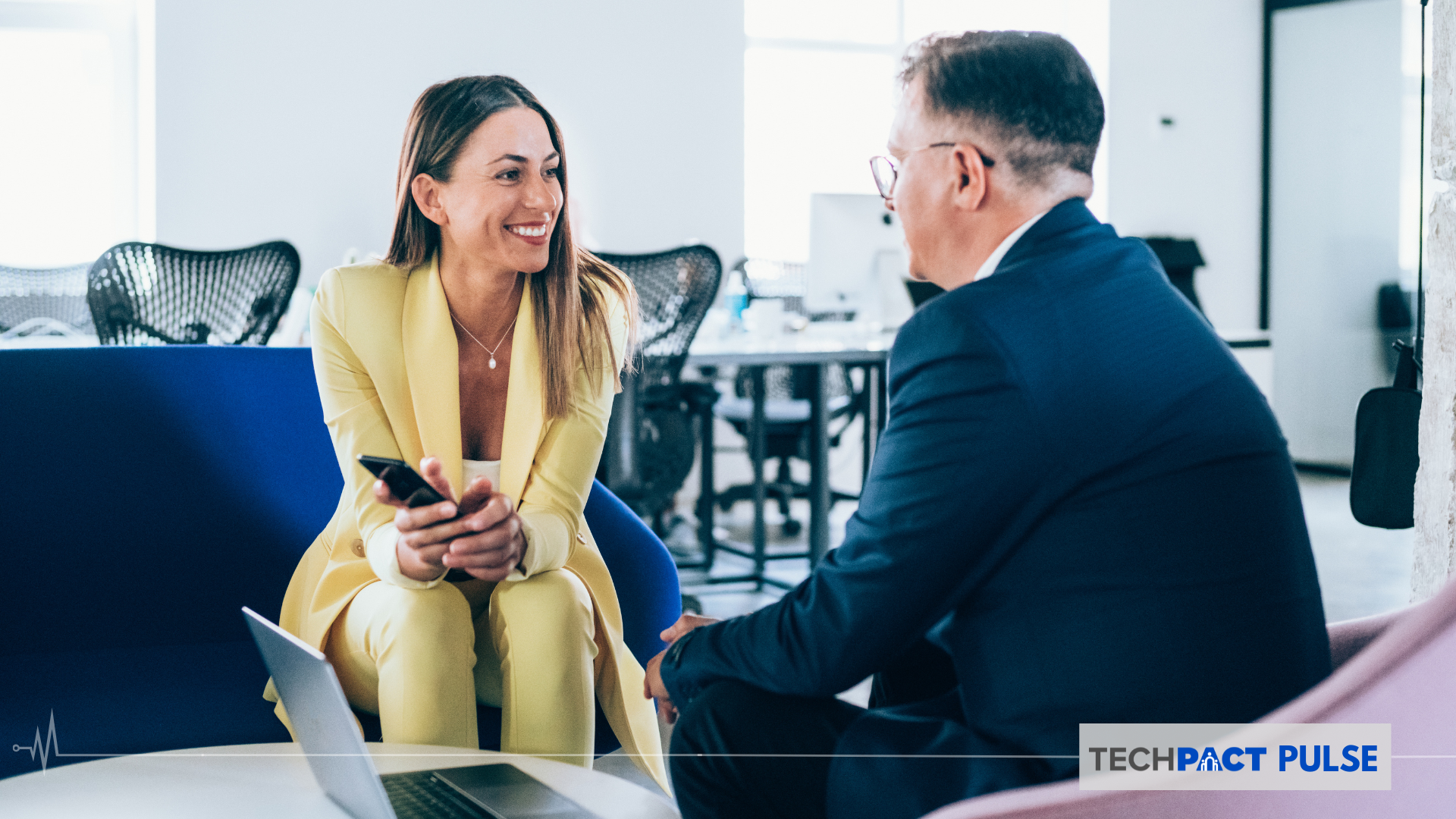  a man and a woman having a conversation in a proffessional setting